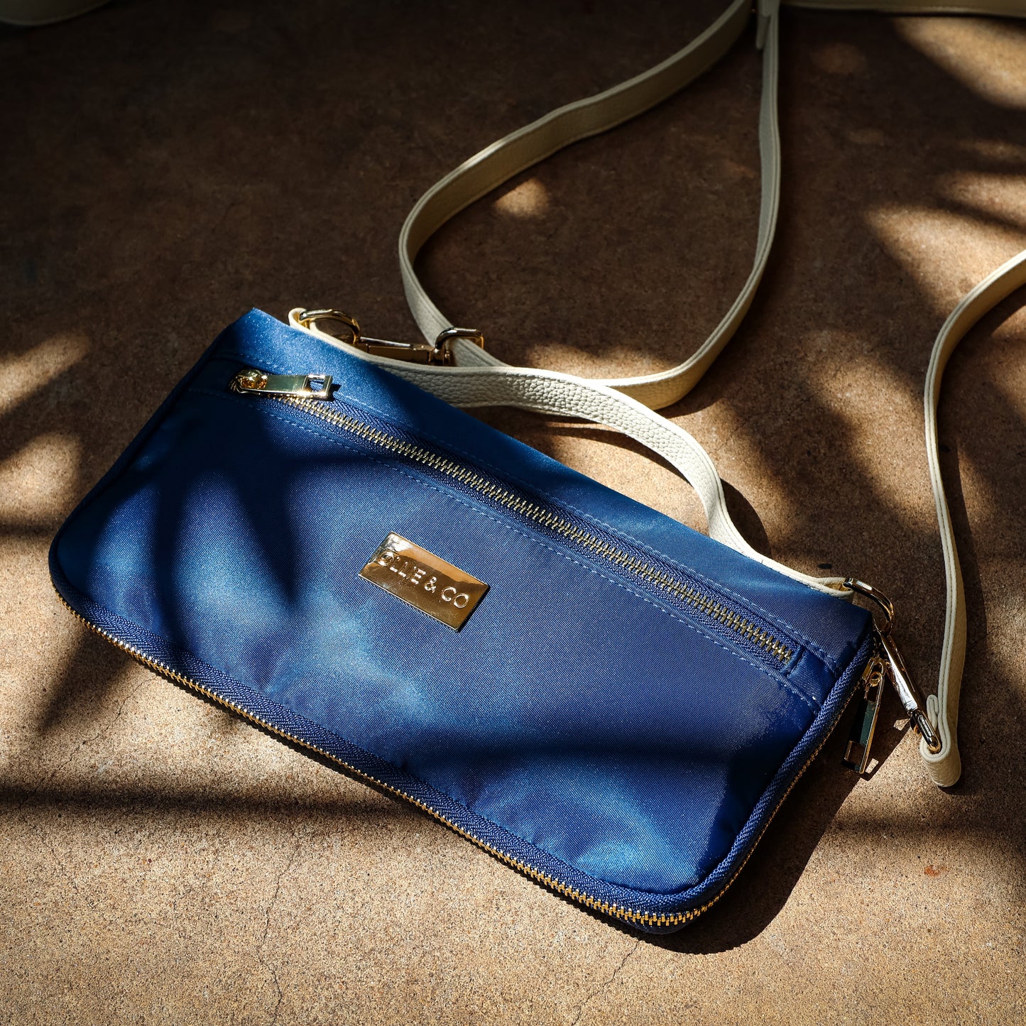 Blue handbag with a visible brand logo on a textured surface